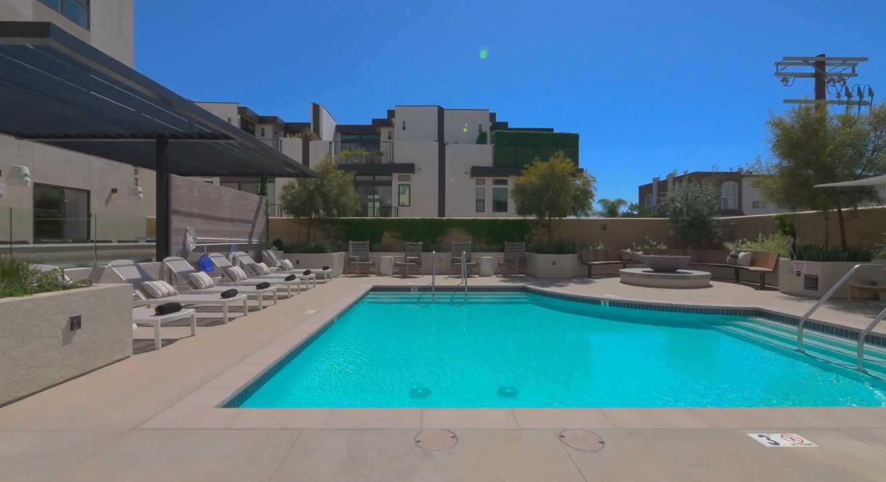 Resort-style pool Resort-style swimming pool with lounge seating